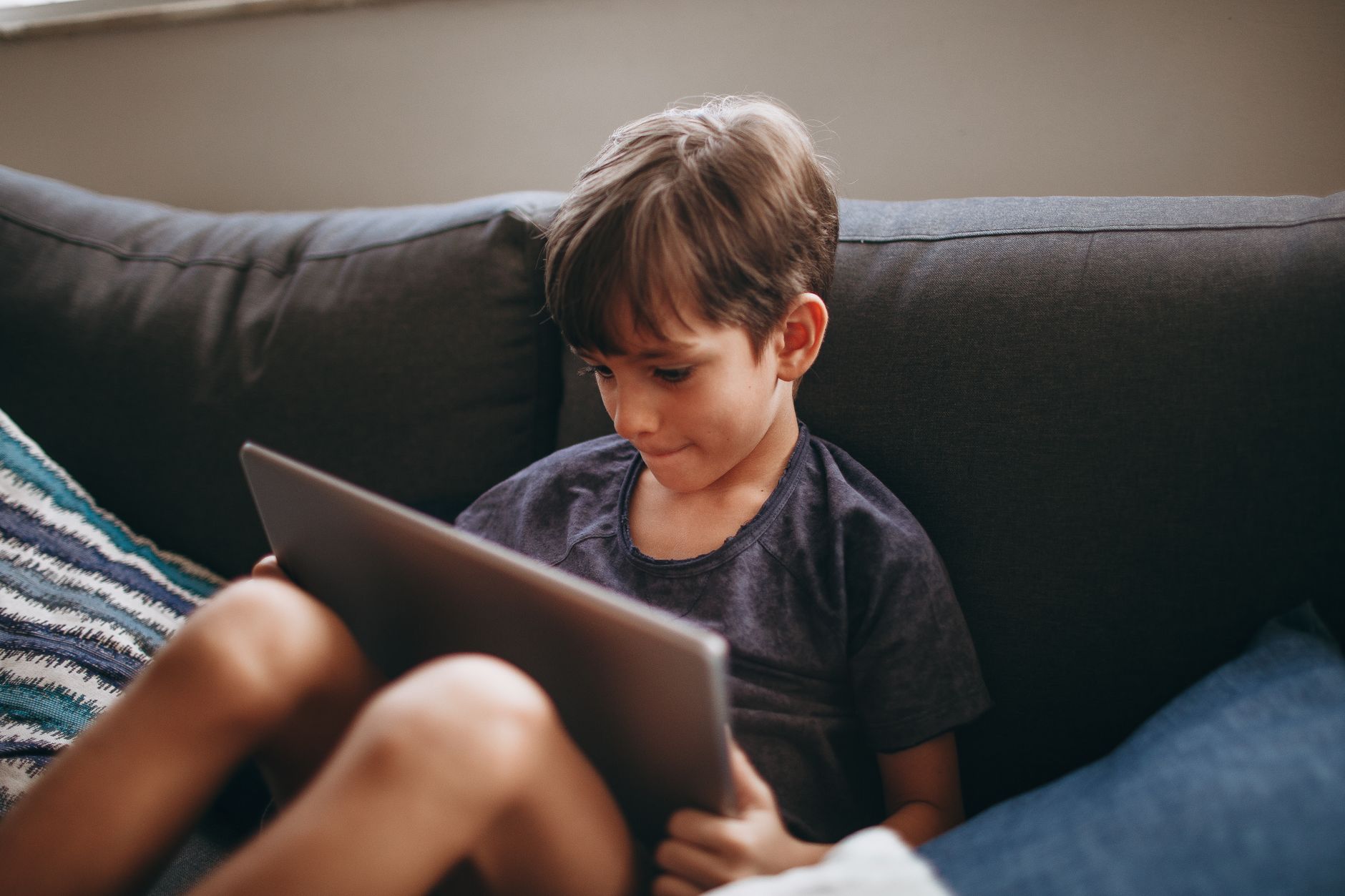 A child absorbed in a tablet during free time