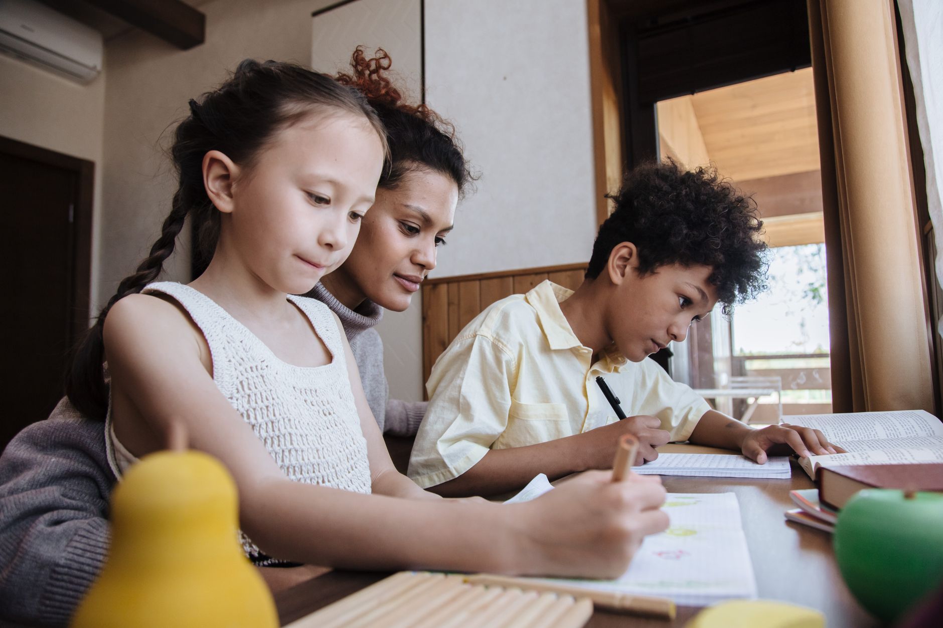 A mother and two children working through a family habit plan together